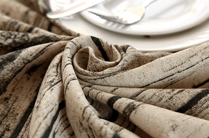 Close-up of rustic wood grain texture on premium linen tablecloth with vintage table setting