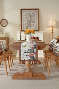 Detailed close-up of patterned table runner with moon castle motifs and colorful tassels