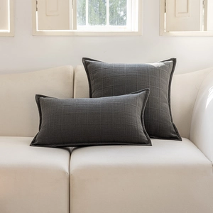 Detail showing dark grey jacquard check texture on minimalist sofa pillow covers
