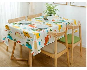 Detailed view of colorful cartoon dinosaur patterns on heavy cotton tablecloth