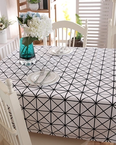 Detailed texture of thick cotton canvas tablecloth with black geometric triangles