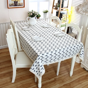 Close-up of modern rectangular tablecloth with blue whale prints and crochet lace edges