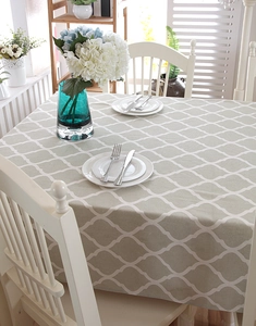 Detail of grey geometric diamond pattern tablecloth with elegant lace trim