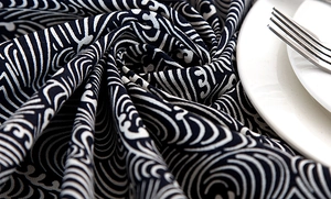 Close-up of Japanese wave pattern table cloth with textured fabric and lace edges