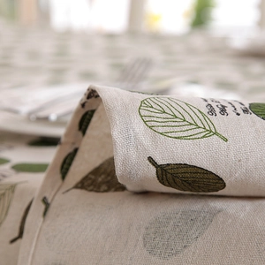Close-up of leaf pattern and woven texture on natural linen cotton tablecloth