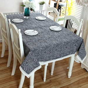 Detailed close-up of blue Japanese wave pattern tablecloth with white lace edges