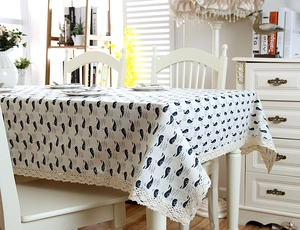 Detail of nautical whale pattern tablecloth with elegant crochet lace edge trim