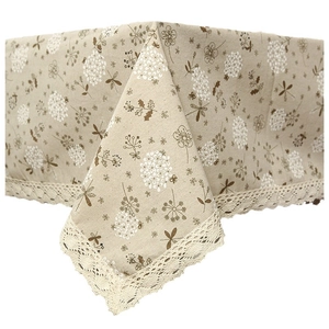Pastel beige floral tablecloth with white dandelion lace border in a pastoral style