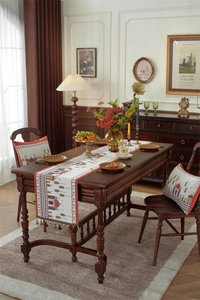 Close-up of jacquard table runner and matching pillows with Middle Eastern motifs