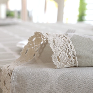 Detail of grey geometric lace tablecloth with hand-crafted hollow crochet lace edge textures