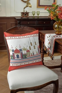 Detail of Middle East woven cushion featuring mosque and palm tree embroidery on a vintage chair