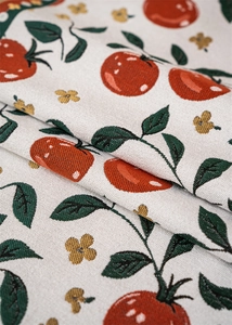 Close-up of tropical fruit jacquard fabric with thick texture and tassel details