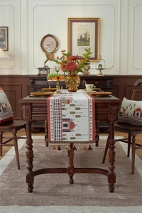 Detail of jacquard table runner with mosque patterns and brown decorative tassels