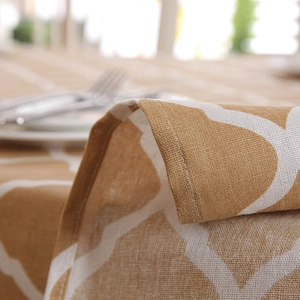 Close-up of yellow geometric pattern tablecloth showing cotton linen texture and stitching