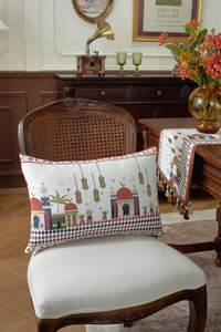 Detail of rectangular lumbar pillow with mosque motifs on a vintage wooden chair