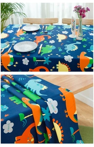Detail of thick cotton tablecloth featuring colorful cartoon dinosaur prints for kids