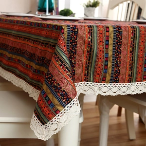 Detailed macro view of bohemian striped table cloth with elegant white crochet lace edge