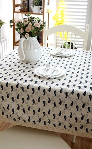 Detail of rectangular whale pattern tablecloth with delicate white lace crochet edges