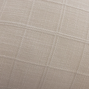 Macro shot of light beige textured cushion cover featuring a detailed woven grid pattern
