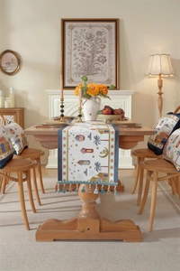 Close-up of woven Ramadan table runner with colorful tassels and Middle Eastern patterns