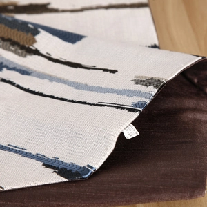 Detailed view of striped jacquard fabric with plush velvet backing and care label