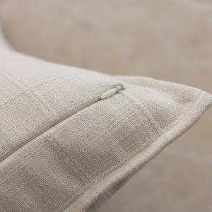 Detailed view of cream jacquard pillowcase fabric with invisible zipper and fine texture