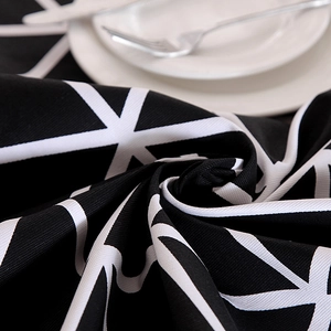 Detailed close-up of thick cotton canvas tablecloth with black and white geometric patterns