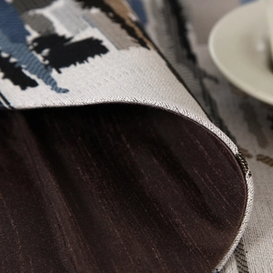 Close-up of woven colorful striped table runner showing jacquard texture and brown lining