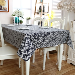 Detailed view of the wavy lace edge and blue wave pattern on the linen tablecloth