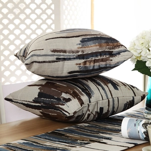 Macro detail of textured abstract stripe patterns on matching pillows and table runner