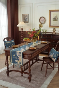 Close-up of jacquard table runner with blue tassels and exotic castle moon patterns