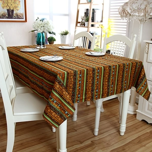 Detailed close-up of Bohemian striped linen tablecloth with decorative lace edges