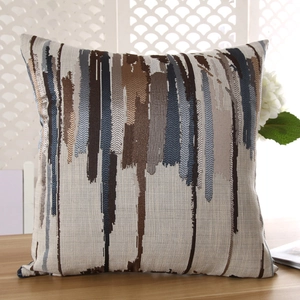 Close-up of artistic vertical striped cushion cover in blue and bronze woven fabric
