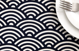 Detail of Seigaiha wave pattern cotton linen tablecloth with ceramic plate and fork
