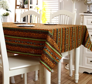 Detail of bohemian gold-stamped stripes on linen tablecloth with elegant lace edges