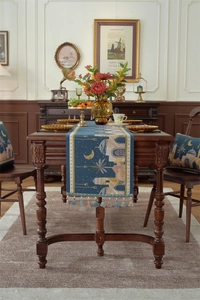 Detail of Middle Eastern style table runner with moon, castle patterns and fringe tassels