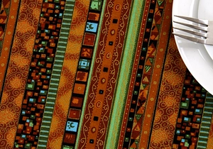 Detail of ethnic striped table runner with gold stamping and delicate lace edge texture