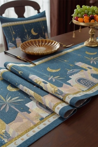 Detail of blue jacquard table runner with golden crescent moon and mosque motifs