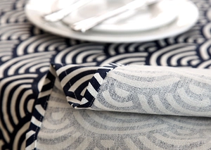 Close-up of blue seigaiha pattern tablecloth with refined wave lace edge and cotton texture