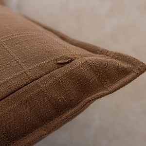 Close-up of brown checkered pillow cover fabric with a hidden zipper closure