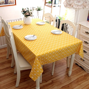 Detail of yellow geometric checkered tablecloth showing high-quality fabric texture