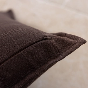 Close-up of the invisible zipper and dark brown textured fabric on the cushion cover