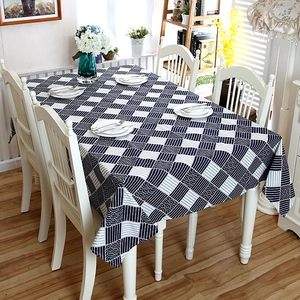 Close-up of blue and white checkered tablecloth with wavy lace edge and texture details
