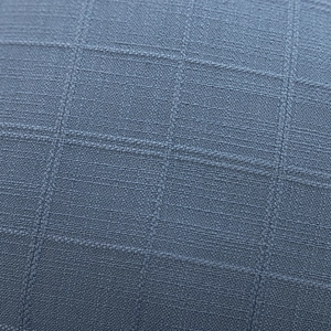 Macro view of blue-gray polyester jacquard fabric with textured grid weave pattern