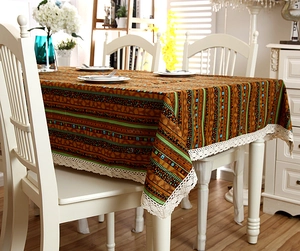 Detail of brown ethnic geometric tablecloth with white hollow lace border trim