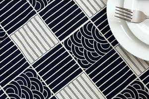 Detail of navy blue geometric Seigaiha pattern tablecloth with wavy lace edge
