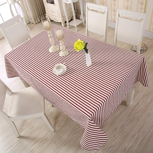 Detailed top view of red and white striped polyester cotton tablecloth on dining table