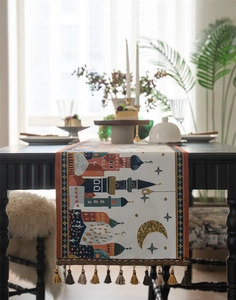Detailed jacquard table runner with moon and castle patterns and colorful tassels