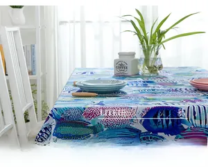 Close-up of thick cotton tablecloth featuring colorful tropical fish and marine life patterns