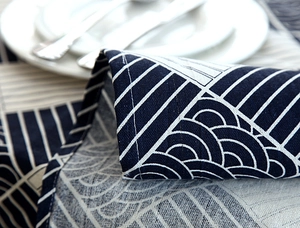 Detailed macro view of navy blue cotton linen tablecloth with wave pattern and lace trim